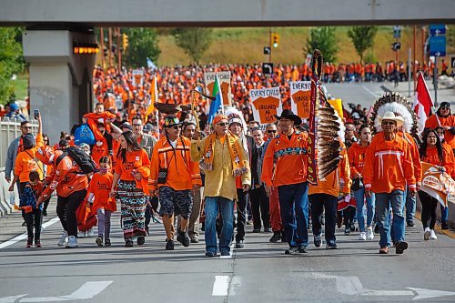 Hundreds of people take part in the march toward Winnipeg's RBC Convention Centre from The Forks during the National Day of Truth and Reconciliation on Friday. (Winnipeg Free Press)