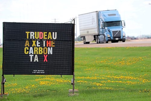 A semi trailer passes by a sign opposing the federal carbon tax on Highway 10 outside Boissevain last week. (Tim Smith/The Brandon Sun)