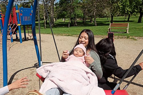 28052024
Krisel Escobilla swings with her six-month-old niece Avrielle San Diego and her mother Edna Escobilla at Riverbend Park in Neepawa on Tuesday as her sister (Avrielle&#x2019;s mother) Karla San Diego (not shown) pushes.
(Tim Smith/The Brandon Sun)