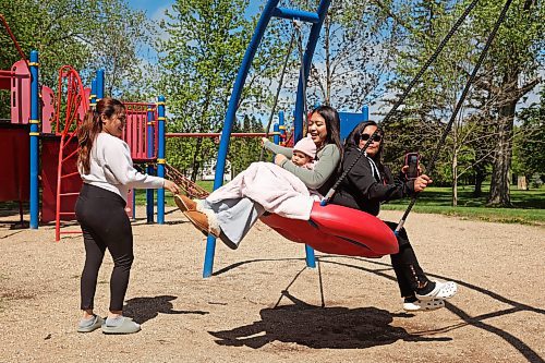 28052024
Krisel Escobilla swings with her six-month-old niece Avrielle San Diego and her mother Edna Escobilla at Riverbend Park in Neepawa on Tuesday as her sister (Avrielle&#x2019;s mother) Karla San Diego pushes.
(Tim Smith/The Brandon Sun)