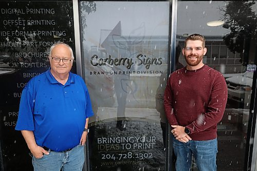 Carberry Signs Brandon print division manager Tom Wenham (left) and co-owner Mike Fedak outside the former Brandon Sun building. (Abiola Odutola/The Brandon Sun)