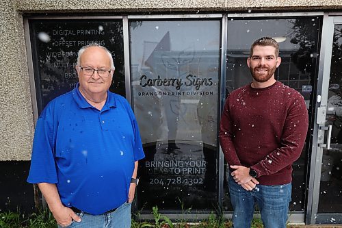 Carberry Signs Brandon print division manager Tom Wenham (left) and co-owner Mike Fedak outside the former Brandon Sun building. (Abiola Odutola/The Brandon Sun)