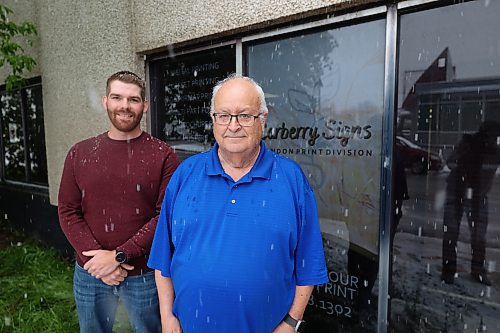 Carberry Signs co-owner Mike Fedak (left) and Brandon print division manager Tom Wenham outside the former Brandon Sun building. (Abiola Odutola/The Brandon Sun)