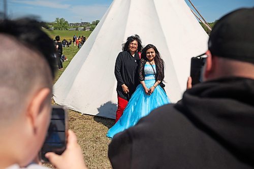 Graduate Brytanna Linklater of École Secondaire Neelin High School has photos taken with her mom Arla during the Our Journey event at the Riverbank Discovery Centre on Wednesday. The event honoured Indigenous students including graduates from local elementary schools, high schools, college and university. It included a powwow, a pipe ceremony, a barbecue lunch and a late afternoon feast. 
(Tim Smith/The Brandon Sun)