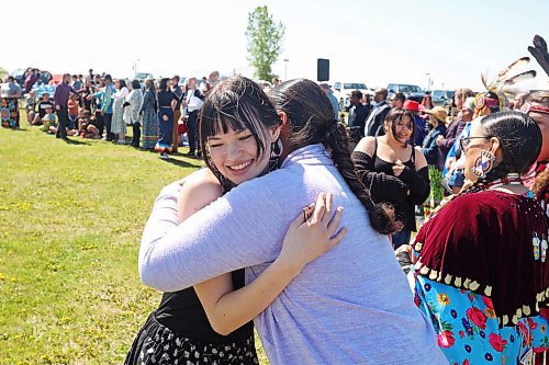 Graduate Ella Chelkowski of École Secondaire Neelin High School gets a hug while being congratulated by dignitaries during the Our Journey event at the Riverbank Discovery Centre on Wednesday. (Tim Smith/The Brandon Sun)