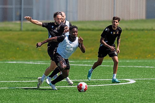 MIKE DEAL / FREE PRESS
Valour FC Raphael Ohin charges ahead while Jordan Swibel tries to slow him down during practice at the Ralph Cantafio Soccer Complex Wednesday.
240529 - Wednesday, May 29, 2024.