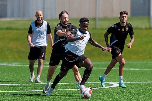 MIKE DEAL / FREE PRESS
Valour FC Raphael Ohin charges ahead while Jordan Swibel tries to slow him down during practice at the Ralph Cantafio Soccer Complex Wednesday.
240529 - Wednesday, May 29, 2024.