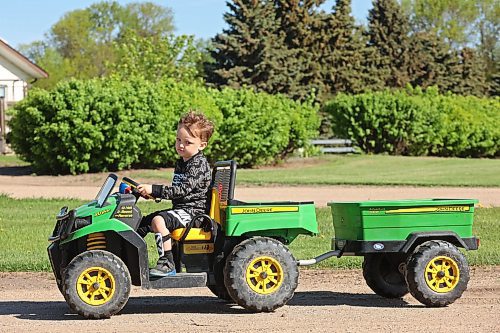 29052024
Three-year-old Ryder Mowatt drives his John Deere XUV down the lane from his home to his grandparents home at their dairy farm south of Brandon on Wednesday. 
(Tim Smith/The Brandon Sun)