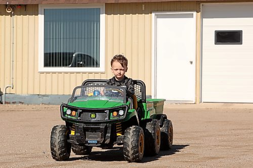 29052024
Three-year-old Ryder Mowatt drives his John Deere XUV at his grandparents dairy farm south of Brandon on Wednesday. 
(Tim Smith/The Brandon Sun)