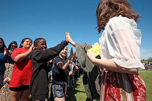 29052024
Students from King George School cheer for Indigenous graduates from the school as they take part in the Our Journey: Celebrating Indigenous Student Success event at the Riverbank Discovery Centre on Wednesday. The event honoured Indigenous students including graduates from local elementary schools, high schools and college/university. It included a powwow, a pipe ceremony, a BBQ lunch and a late afternoon feast. 
(Tim Smith/The Brandon Sun)