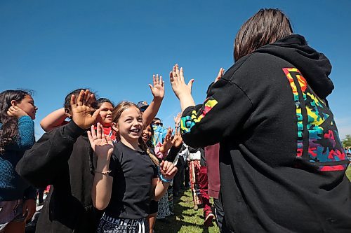 29052024
Students from King George School cheer for Indigenous graduates from the school as they take part in the Our Journey: Celebrating Indigenous Student Success event at the Riverbank Discovery Centre on Wednesday. The event honoured Indigenous students including graduates from local elementary schools, high schools and college/university. It included a powwow, a pipe ceremony, a BBQ lunch and a late afternoon feast. 
(Tim Smith/The Brandon Sun)