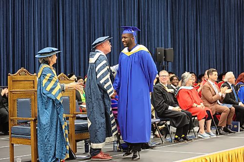 Brandon University president David Docherty congratulates Chukwuanugo Okudo on earning his bachelor of science degree during the annual convocation ceremony on Thursday morning. (Abiola Odutola/The Brandon Sun)