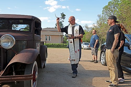 Father Chris Arthur with Redeemer-St. George’s Church in Brandon blesses Curt Stauffer’s 1932 Ford truck during The Road Rebels Blessing of the Wheels Car Show on Thursday evening. The event included a barbecue, with proceeds going to the Anglican Memorial Camp. Local car enthusiasts brought their cars to be blessed. (Photos by Tim Smith/The Brandon Sun)