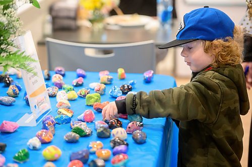 Mike Sudoma/Free Press
RMHC outpatient Tobias Scott picks out a painted stone decorated by families that are currently staying/patients of Ronald McDonald House Thursday afternoon
May 30, 2024