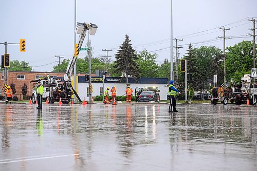 Mike Sudoma/Free Press
WPS and Cadets members direct traffic in the rain while Manitoba Hydro workers fix a traffic light that was run into by a car early Thursday afternoon
May 30, 2024