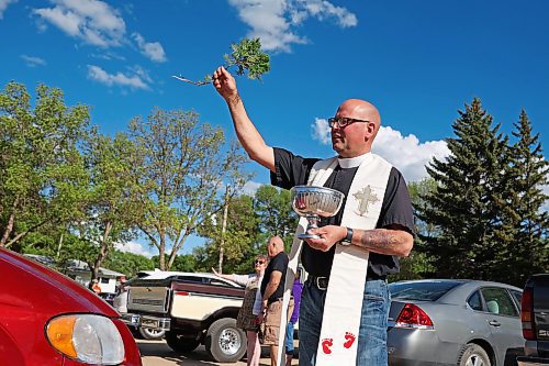 30052024
Father Chris Arthur with Redeemer-St. George&#x2019;s Church in Brandon blesses cars during The Road Rebels Blessing of the Wheels Car Show on Thursday evening. The event included a BBQ with proceeds going to the Anglican Memorial Camp. Local car enthusiasts brought their cars to be blessed.
(Tim Smith/The Brandon Sun)