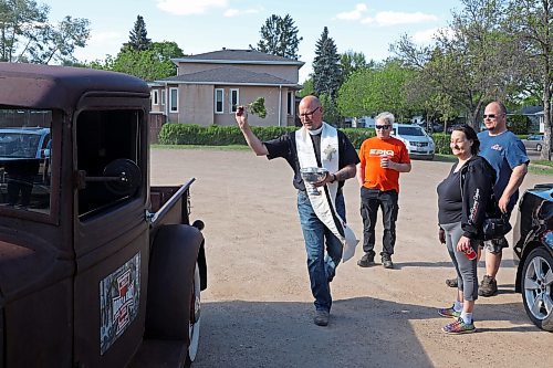 30052024
Father Chris Arthur with Redeemer-St. George&#x2019;s Church in Brandon blesses Curt Stauffer&#x2019;s 1932 Ford truck during The Road Rebels Blessing of the Wheels Car Show on Thursday evening. The event included a BBQ with proceeds going to the Anglican Memorial Camp. Local car enthusiasts brought their cars to be blessed.
(Tim Smith/The Brandon Sun)