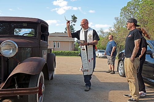 30052024
Father Chris Arthur with Redeemer-St. George&#x2019;s Church in Brandon blesses Curt Stauffer&#x2019;s 1932 Ford truck during The Road Rebels Blessing of the Wheels Car Show on Thursday evening. The event included a BBQ with proceeds going to the Anglican Memorial Camp. Local car enthusiasts brought their cars to be blessed.
(Tim Smith/The Brandon Sun)