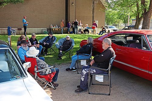 30052024
Car enthusiasts mingle during The Road Rebels Blessing of the Wheels Car Show at Redeemer-St. George&#x2019;s Church on Thursday evening. The event included a BBQ with proceeds going to the Anglican Memorial Camp. Local car enthusiasts brought their cars to be blessed by Father Chris Arthur. 
(Tim Smith/The Brandon Sun)