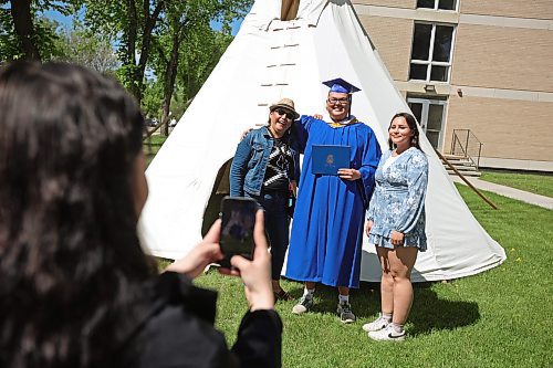 30052024
Graduate Dante Cameron (C) has photos taken with his aunt Shelley Cameron and cousin Dasante Cameron after Brandon University&#x2019;s convocation for the Faculty of Education at the BU Healthy Living Centre on Thursday. 
(Tim Smith/The Brandon Sun)