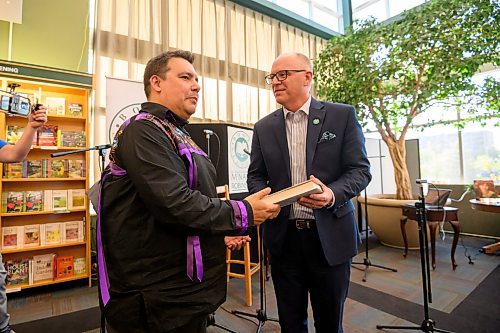 Mike Sudoma/Free Press
Writer Niigaan Sinclair hands Winnipeg Mayor Scott Gillingham a signed copy of his newly launched book Winip&#xea;k; Visions of Canada from an Indigenous Centre at McNally Robinson Thursday night
May 30, 2024