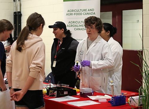 A representative from Agri-Food Canada speaks with a high school student from Crocus Plains Regional Secondary School during the career fair in the school's gymnasium on Friday. (Michele McDougall/The Brandon Sun)