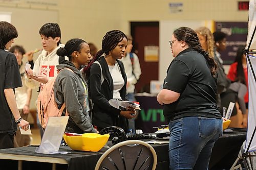 Two Crocus Plains students listen to a representative from New Holland Agriculture during the career fair on Friday. (Michele McDougall/The Brandon Sun)
