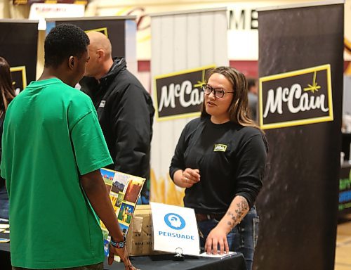 A high school student from Crocus Plains Regional Secondary School listen to a representative from McCain Foods Canada during a career fair hosted by Agriculture in the Classroom-Manitoba (AITC-M) in the school's gymnasium on Friday. The career fair was designed to let students know about the diverse career opportunities available in the agriculture and supporting food industries. (Michele McDougall/The Brandon Sun)
'