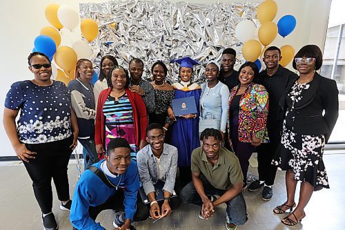 Bachelor of nursing graduate Oluchukwu Gladness Chijioke poses for picture with her family and friends. (Abiola Odutola/The Brandon Sun)