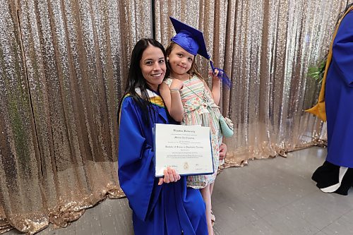 Melissa Cumming, graduating with a bachelor of science in psychiatric nursing, and her daughter, McKinley, at the Brandon University 2024 convocation ceremony on Friday morning. (Abiola Odutola/The Brandon Sun)