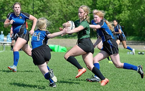 Committed to the Brandon University Bobcats rugby team this fall, Dauphin Clippers co-captain Megan Thompson — just look for her orange cleats on the pitch — looks to elude incoming Souris Sabres tacklers during her team's 92-0 victory Friday afternoon at Kin Field. (Jules Xavier/The Brandon Sun)