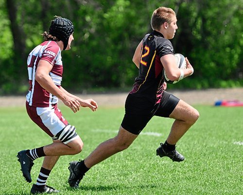 Crocus Plainsmen ball carrier Kayden MacEachern eludes a St. Paul's Crusaders player as he looks for open space along the sidelines en route to moving the ball upfield during Friday afternoon's Manitoba High Schools Athletic Association provincials in Dauphin at Kin Field. (Jules Xavier/The Brandon Sun)