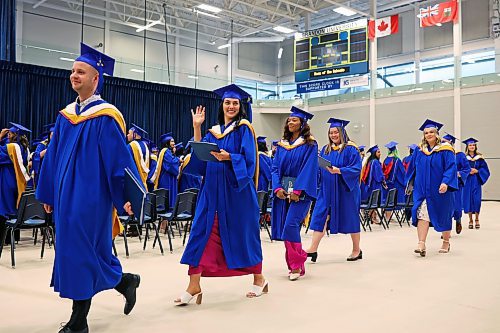 A graduate waves to supporters in the crowd at the end of Brandon University’s convocation for the Faculty of Health Studies at the BU Healthy Living Centre on Friday morning. (Tim Smith/The Brandon Sun)