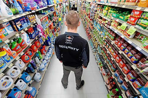 MIKE DEAL / FREE PRESS ILLUSTRATION 
An Impact Security guard walks down a grocery isle.
240531 - Friday, May 31, 2024.