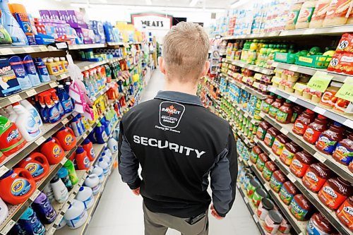 MIKE DEAL / FREE PRESS ILLUSTRATION 
An Impact Security guard walks down a grocery isle.
240531 - Friday, May 31, 2024.