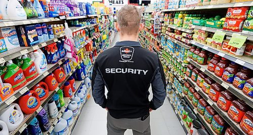 MIKE DEAL / FREE PRESS ILLUSTRATION 
An Impact Security guard walks down a grocery isle.
240531 - Friday, May 31, 2024.