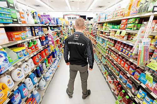 MIKE DEAL / FREE PRESS ILLUSTRATION 
An Impact Security guard walks down a grocery isle.
240531 - Friday, May 31, 2024.