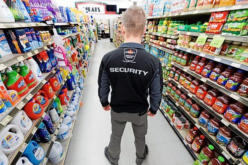 MIKE DEAL / FREE PRESS ILLUSTRATION 
An Impact Security guard walks down a grocery isle.
240531 - Friday, May 31, 2024.