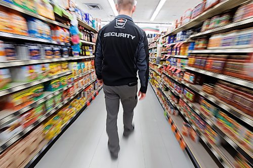 MIKE DEAL / FREE PRESS ILLUSTRATION 
An Impact Security guard walks down a grocery isle.
240531 - Friday, May 31, 2024.