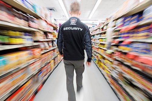 MIKE DEAL / FREE PRESS ILLUSTRATION 
An Impact Security guard walks down a grocery isle.
240531 - Friday, May 31, 2024.