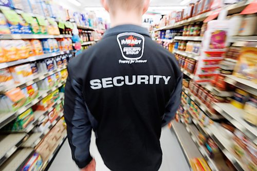 MIKE DEAL / FREE PRESS ILLUSTRATION 
An Impact Security guard walks down a grocery isle.
240531 - Friday, May 31, 2024.