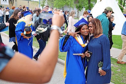 31052024
Simi Azeez, a bachelor of nursing with distinction graduate, has photos taken with her mom Adejoke Azeez after Brandon University&#x2019;s convocation for the Faculty of Health Studies at the BU Healthy Living Centre on Friday morning. 
(Tim Smith/The Brandon Sun)31052024

(Tim Smith/The Brandon Sun)