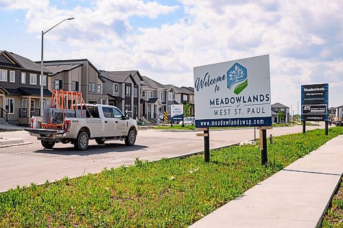 Mike Sudoma/Free Press
A construction truck drives by a sign for Meadowlands Place a newly developed housing development located just outside the city in West St Paul
May 31, 2024