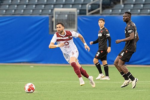 BROOK JONES / FREE PRESS.
Valour FC hosts visiting Vancouver FC in Canadian Premier League soccer action at Princess Auto Stadium in Winnipeg, Man., Sunday, June 2, 2024. Valour FC earned a 2-0 victory over Vancouver FC. Pictured: Valour FC attacker Jordan Swibel (No. 9), who is from Australia, chases the soccer ball as Vancouver FC defender Allan Enyou watches during second half action.