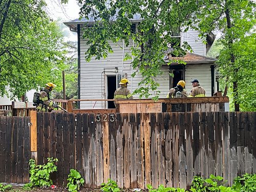 Firefighters work to extinguish a fire in the 300 block of 16th Street early Tuesday morning. (Matt Goerzen/The Brandon Sun)