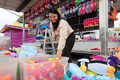 04062024
Kenzie Wiese sets up prizes for the duck pond midway game in preparation for the opening day of the Manitoba Summer Fair at the Keystone Centre grounds on Tuesday. The annual fair opens this afternoon and runs until Sunday. 
(Tim Smith/The Brandon Sun)