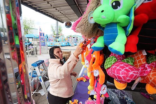 04062024
Kenzie Wiese sets up prizes for the duck pond midway game in preparation for the opening day of the Manitoba Summer Fair at the Keystone Centre grounds on Tuesday. The annual fair opens this afternoon and runs until Sunday. 
(Tim Smith/The Brandon Sun)