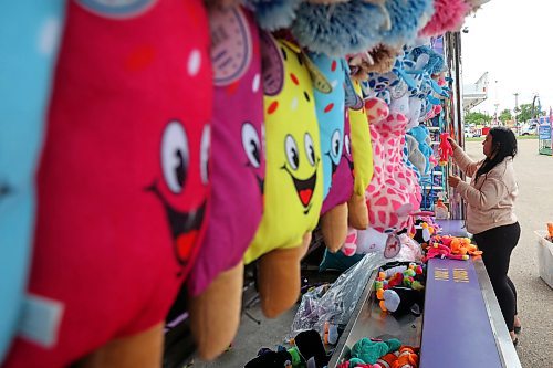 04062024
Kenzie Wiese sets up prizes for the duck pond midway game in preparation for the opening day of the Manitoba Summer Fair at the Keystone Centre grounds on Tuesday. The annual fair opens this afternoon and runs until Sunday. 
(Tim Smith/The Brandon Sun)