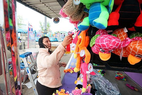 04062024
Kenzie Wiese sets up prizes for the duck pond midway game in preparation for the opening day of the Manitoba Summer Fair at the Keystone Centre grounds on Tuesday. The annual fair opens this afternoon and runs until Sunday. 
(Tim Smith/The Brandon Sun)