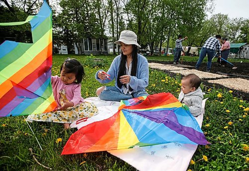 JOHN WOODS / FREE PRESS
ThaMu Eh, plays with her daughters Willow (pink) and Meadow (grey), as her mother Nyo You San, father Doh Htoo Eh and her grand mother work in the garden at their multi-generational home north of Stonewall Tuesday, May 21, 2024. 

Reporter: gabby